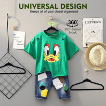 Black velvet kids hanger holding a green graphic T-shirt, with swivel hook