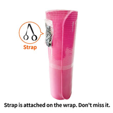 Pink yoga mat with black carrying strap, shown wrapped