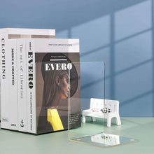 Clear acrylic bookends holding books upright on a small clear base.