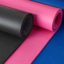 Rolled yoga mat pair in pink and blue with dark gray ribbed texture