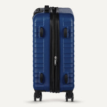Navy blue hard-shell spinner suitcase with side zipper and dual wheels visible