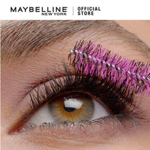 Mascara-coated eyelashes with dark lashes and purple-tinted tips over an eye