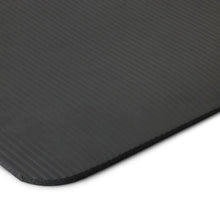 Close-up of dark gray yoga mat edge with textured, non-slip surface