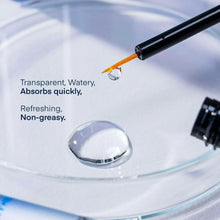 Clear serum drop from applicator tip of eyelash and brow growth serum