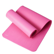 Pink yoga mat with rolled layers showing ribbed textured surface