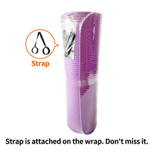 Rolled purple yoga mat in plastic wrap with attached carrying strap