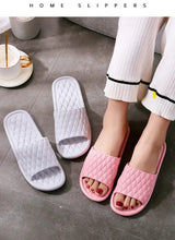 White and pink open-toe slide slippers with quilted pattern