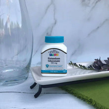 Potassium gluconate supplement bottle with blue cap on tabletop