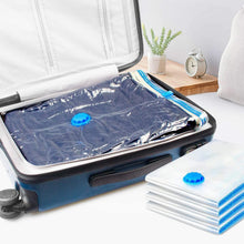 Vacuum storage bag compressing bedding in a zip travel suitcase with blue valve caps