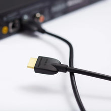 Black HDMI cable with gold-plated HDMI plug, close-up