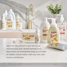 Multiple Young Living Thieves cleaner bottles and sprays arranged on a shelf