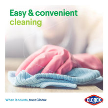 Cleaning cloths on a surface: pink cloth and folded blue microfiber towel