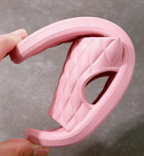 Pink shower slipper outsole and side, textured quilted upper