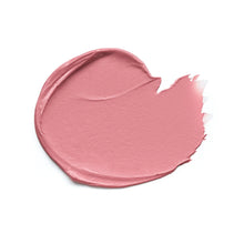 Pink blush cream texture smear on a white surface