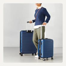 Navy blue hardside spinner suitcase set with two standing shells and wheels