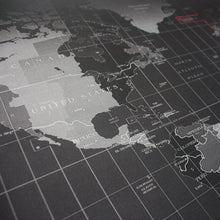 Close-up of black world map design on a gaming mouse pad with fine grid lines