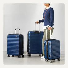 Navy blue hardside spinner luggage set with telescoping handles and wheels