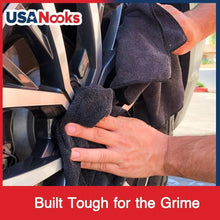 Microfiber cleaning cloth pressed against a car front grille for cleaning