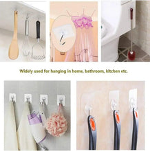 Transparent adhesive hooks with chrome metal S hooks holding bathroom and kitchen items