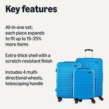 Two blue hardside spinner suitcases with textured shell, telescoping handle, and wheels