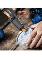 KOMAX mini hot glue gun applying glue to heart-shaped ornament