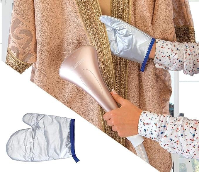Hand steaming brown fabric with silver nozzle; steam cloth pad on side.