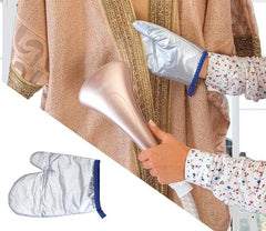 Hand steaming brown fabric with silver nozzle; steam cloth pad on side.