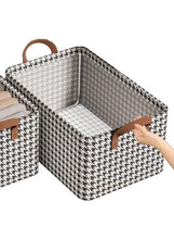 Fabric drawer organizer with black-and-white houndstooth pattern, brown handles, and a reinforced interior
