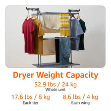 Indoor clothes dryer tower holding hanging shirts and towels over three drying racks.