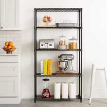 Black metal wire 5-shelf storage rack standing in a kitchen with items on tiers