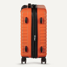 Orange hardside spinner suitcase with telescoping handle and black zipper trim