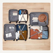 Open navy blue hardside spinner luggage set showing interior compartments