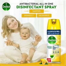 Disinfectant spray bottle beside smiling adult and baby with yellow citrus label
