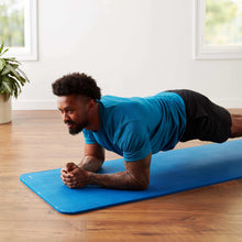 Blue yoga exercise mat in use, showing ribbed grip surface