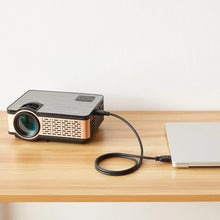 Black HDMI cable running between media player and TV on a desk