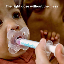 Baby with accu-dose pacifier attached to clear medicine syringe