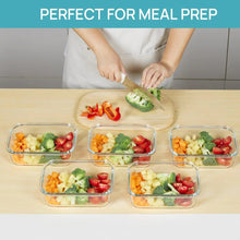 Set of clear glass meal prep containers with snap lids, filled with vegetables and fruit