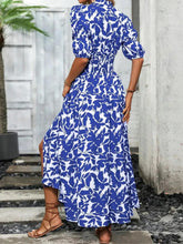 Blue and white floral print maxi dress with V-neck and tiered skirt with slit