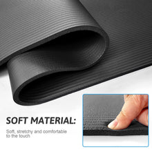 Dark gray yoga mat with soft textured surface and rolled underside close-up
