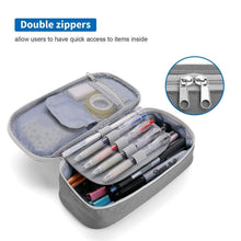 Gray pencil case open with two zip openings and internal pen compartments.