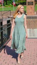 Sage green sleeveless tiered maxi dress with smocked bodice and scoop neckline