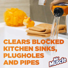 Orange Mr. Muscle drain cleaner bottle pouring clear liquid into kitchen sink