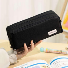 Black zip pencil case with small logo label, smooth fabric and metal zipper pulls
