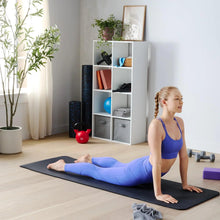 Black yoga mat with textured surface for floor exercises