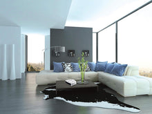 Compact Black+Decker white fan heater placed on a table, front grille visible