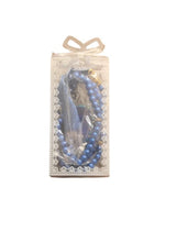 Blue prayer beads with decorative charm, in a lace-style gift bag with ribbon