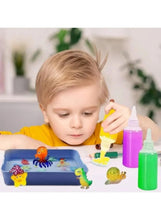 Child painting in a blue tray with ocean animal toys and squeeze paint bottles