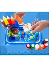 Water art tray with colorful animal shapes made using squeeze paint bottles