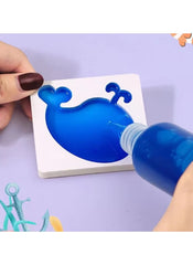 Huitich 9-color water art kit for children pouring blue paint into whale stencil