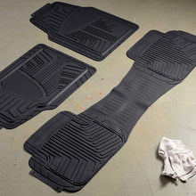 Black 3-piece rubber floor mat set with textured channels on a light concrete floor